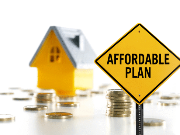 Affordable housing plan concept with yellow house model and stacked coins symbolizing budget-friendly investment options.