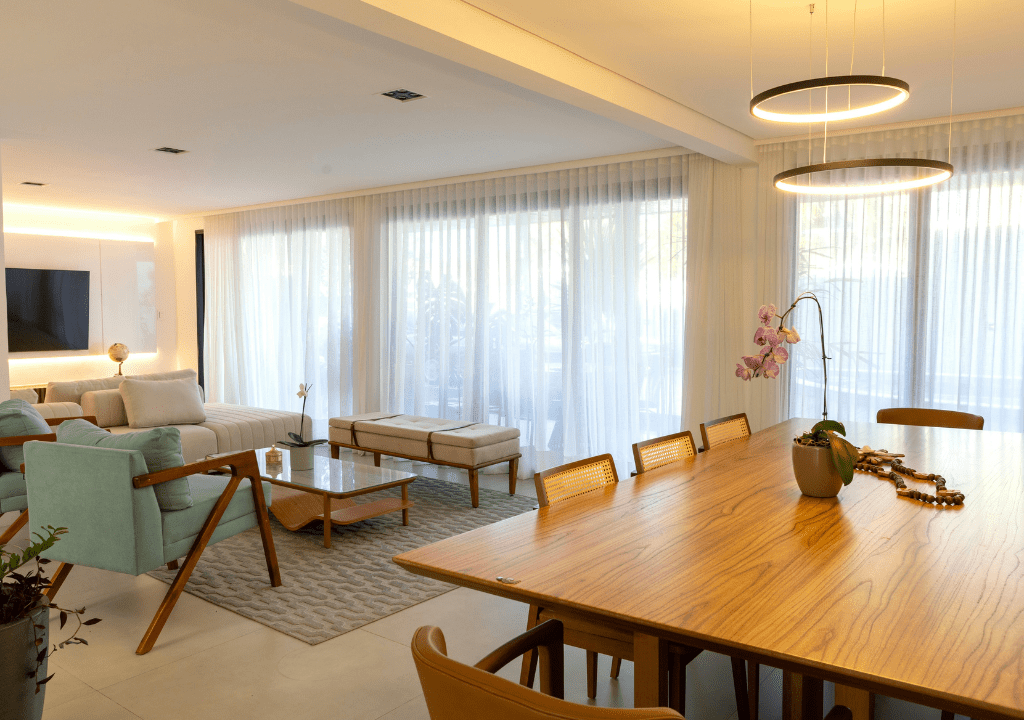 Modern luxury living and dining room interior featured in an Al-Mannan Developers home, showcasing bright natural light, elegant furniture, and contemporary design.